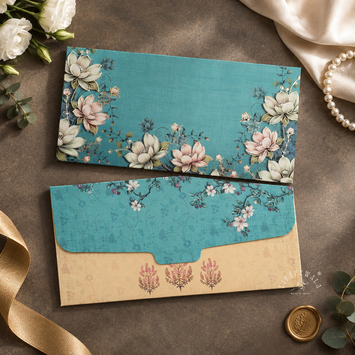 Teal Lotus Garden velvet shagun envelope by LIFAFEWALA – styled flat lay