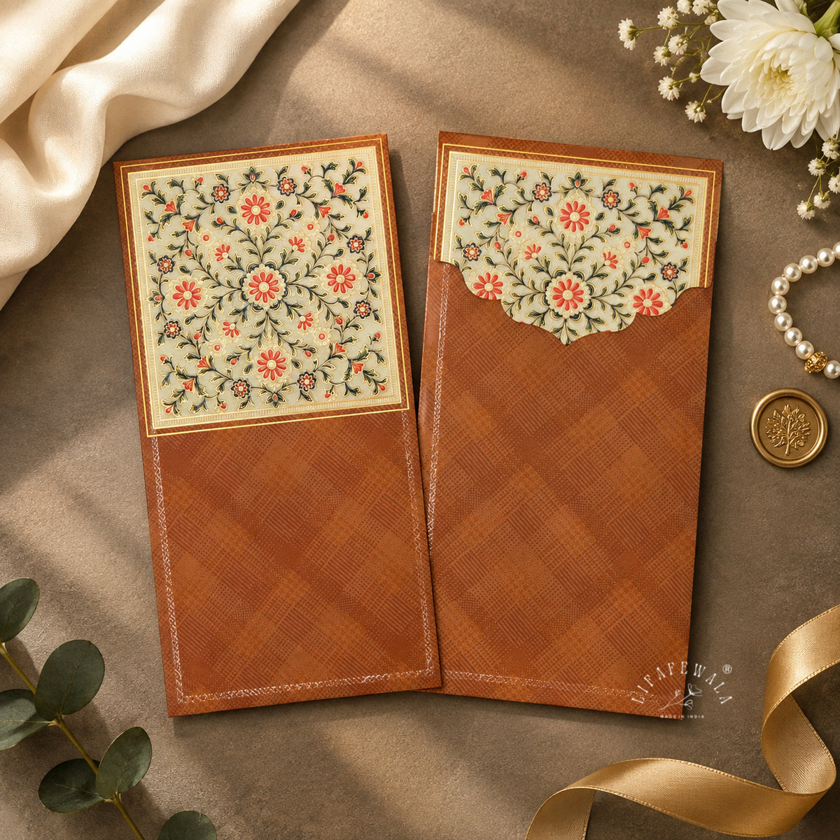 Rust Mughal Floral vertical velvet UV shagun envelope by LIFAFEWALA – styled flat lay